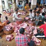 Butchers are busy preparing meat after slaughtering sacrificial animals at Jamia Naeemiyah on the first day of Eidul Azha