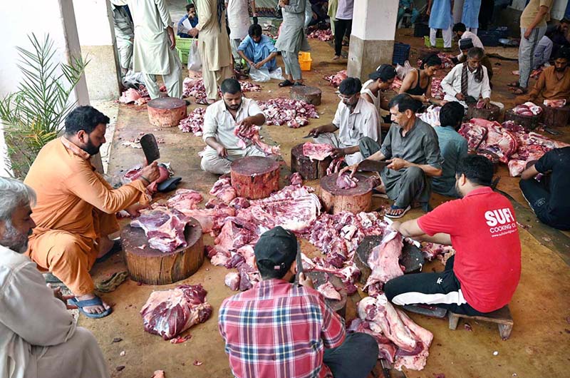 Butchers are busy preparing meat after slaughtering sacrificial animals at Jamia Naeemiyah on the first day of Eidul Azha