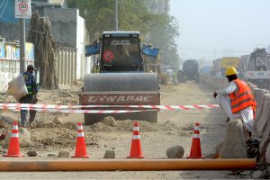 Heavy machinery is being used to extend the road as construction work continues in the Jail Chowrangi area under a city development project
