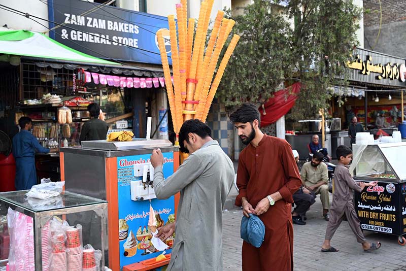Vendor display and sell cone ice-cream to attract customers on a hot day in the city at Stadium Road