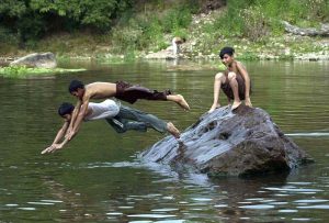 Youngsters diving in the Rawal Lake spillway stream water to beat the heat in a hot day experiencing in the federal capital.