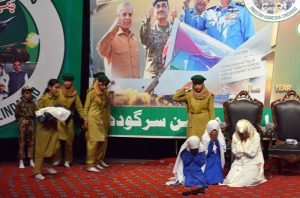 Students perform a tableau marking the completion of one year of the victory of Marka-e-Haq Bunyan-ul-Marsoos at Arts Council