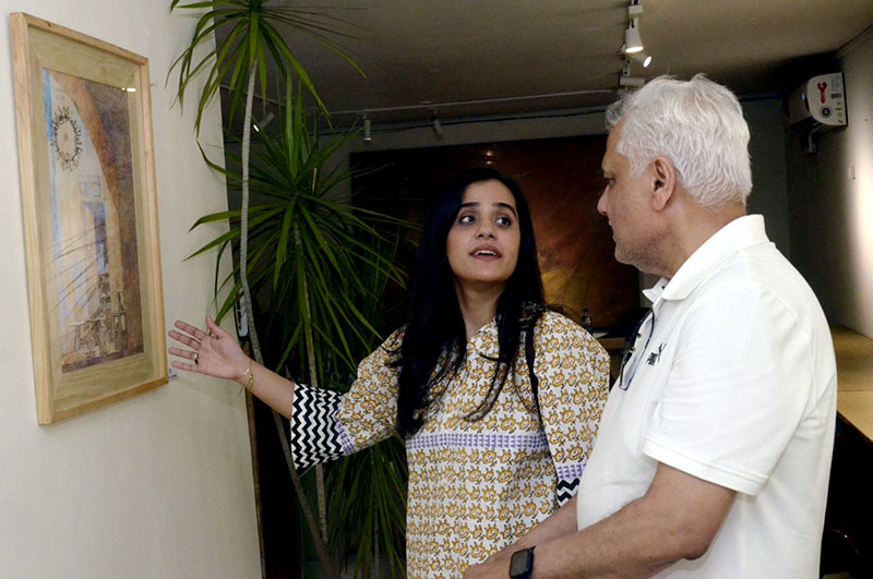 Visitors view an art display by artists at an exhibition held at the Shakir Ali Museum