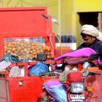A man sells gol gappay from a motorcycle to earn his livelihood