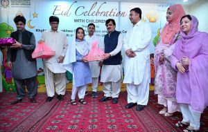 Secretary Social Welfare Sharif Hussain and Chief Child Commission Ijaz Khan along with other officials distributing Eid gifts among the children of Zamung Kor Institute and Special Education Complex.