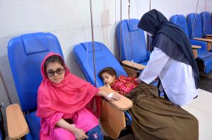 Young thalassemia patients receive a blood transfusion at a Hamza Foundation medical center on the eve of World Thalassemia Day