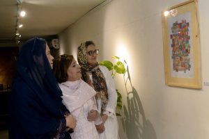 Visitors view an art display by artists at an exhibition held at the Shakir Ali Museum