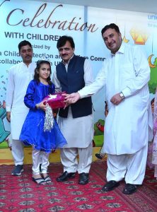 Secretary Social Welfare Sharif Hussain and Chief Child Commission Ijaz Khan along with other officials distributing Eid gifts among the children of Zamung Kor Institute and Special Education Complex.