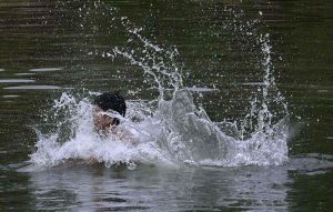 Youngsters diving in the Rawal Lake spillway stream water to beat the heat in a hot day experiencing in the federal capital.