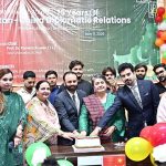 President Faisalabad Chamber of Commerce & Industry (FCCI) Farooq Yousaf Sheikh with Prof. Dr. Kanwal Ameen. Vice Chancellor GCWUF cutting cake during commemorating 75 years of Pakistan-China Diplomatic Relations arranged by Government College Women University Faisalabad (GCWUF) at Jinnah Auditorium
