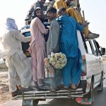 Passengers traveling on the rooftop of a van at Larkana-Dadu Road may cause any mishap and needs the attention of concerned authorities
