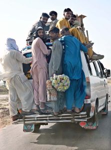 Passengers traveling on the rooftop of a van at Larkana-Dadu Road may cause any mishap and needs the attention of concerned authorities