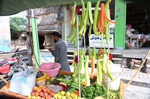 A street vendor sells salad from his cart at Railway Chowk.