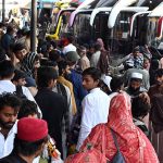 People gather at Badami Bagh bus Stand to celebrate Eid-ul-Azha in their hometown