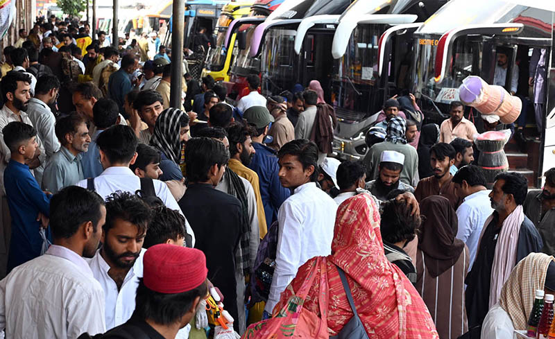 People gather at Badami Bagh bus Stand to celebrate Eid-ul-Azha in their hometown