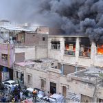Firefighting personnel extinguish a fire at a warehouse in Pukka Fort