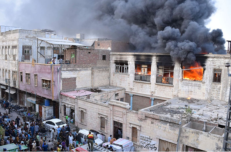 Firefighting personnel extinguish a fire at a warehouse in Pukka Fort
