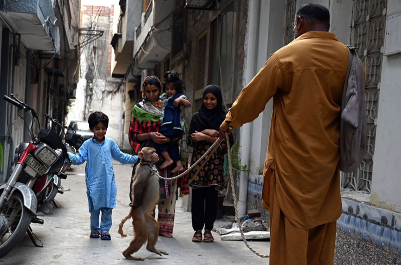 A juggler with his pet monkey showing tricks to earn for livelihood in the Provincial Capital