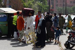 People gather at Badami Bagh bus Stand to celebrate Eid-ul-Azha in their hometown