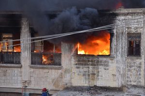 Firefighting personnel extinguish a fire at a warehouse in Pukka Fort