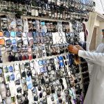 An elderly vendor sells glasses at his roadside stall on Qaim Shah Bukhari Road
