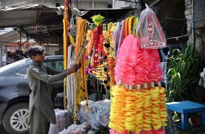 A vendor displays decorative items of sacrificial animals ahead of Eid al Azha in the city.