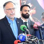 Federal Minister for Planning and Development Ahsan Iqbal talks to media persons during his visit to exhibition stalls at the Expo Centre