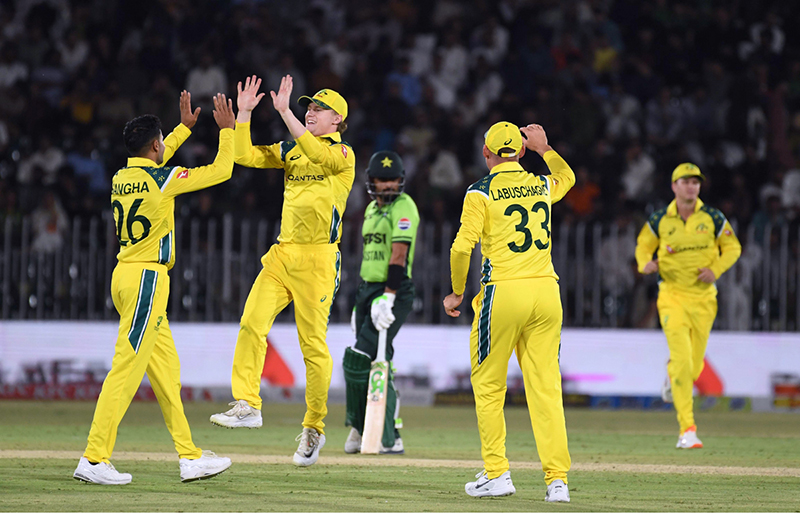 Australian national team players celebrate the wicket of Pakistan’s Sahibzada Farhan during the first One Day International (ODI) between Pakistan national cricket team and Australia national cricket team at the Rawalpindi Cricket Stadium