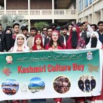 Students participate in a walk organized by the Jammu Kashmir Students Council Punjab University in connection with Kashmir Cultural Day outside Faisal Auditorium at Punjab University