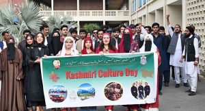 Students participate in a walk organized by the Jammu Kashmir Students Council Punjab University in connection with Kashmir Cultural Day outside Faisal Auditorium at Punjab University