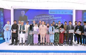 Prime Minister Muhammad Shehbaz Sharif in a group photo with the beneficiaries of PM's Youth Laptop Scheme.
