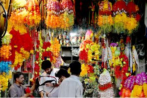A vendor arranges decorative accessories for sacrificial animals at a local market in preparation for Eid al-Azha.