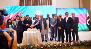 Chairman Senate Syed Yousaf Raza Gilani cutting cake along with dignitaries on occasion of Independence Day of Azerbaijan during a ceremony