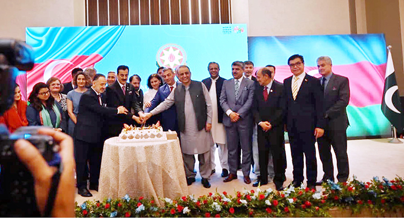 Chairman Senate Syed Yousaf Raza Gilani cutting cake along with dignitaries on occasion of Independence Day of Azerbaijan during a ceremony