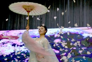 Chinese artist performs a cultural dance with umbrellas during the Pakistan–China Cultural Evening held to mark 75 years of Pak–China friendship at the Pakistan–China Friendship Center in the federal capital.