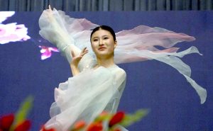 Chinese artist performs a cultural dance with umbrellas during the Pakistan–China Cultural Evening held to mark 75 years of Pak–China friendship at the Pakistan–China Friendship Center in the federal capital.