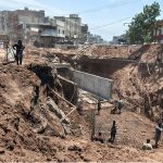 Workers and heavy machinery carry out construction work near Gunj Mandi, as the project progresses to ease traffic congestion and improve the city's road infrastructure