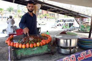 A vendor busy in frying ‘Tawa Kaleji’ for customers at his roadside setup in the Federal Capital