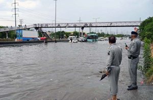 Vehicles passing through rainwater accumulated at IJP Road during heavy rain in the Federal Capital.