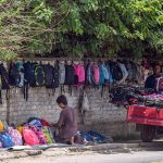 A vendor displays a variety of school bags for sale along a roadside wall in Tipu Road, as parents look to purchase affordable school items ahead of the new academic session