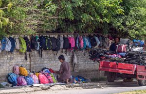 A vendor displays a variety of school bags for sale along a roadside wall in Tipu Road, as parents look to purchase affordable school items ahead of the new academic session