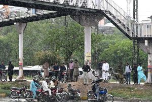 A view of vehicles on the way at Islamabad Highway during rain that experienced the in Federal Capital.