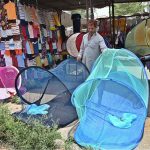 A vendor displays mosquito nets to be used to protect babies from mosquito bites at the I/9-4 weekly bazaar in the Federal Capital