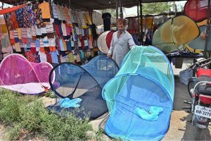 A vendor displays mosquito nets to be used to protect babies from mosquito bites at the I/9-4 weekly bazaar in the Federal Capital