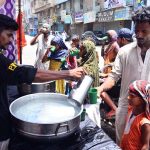 Volunteers serve cool water to people at Hyder chowk during a hot day in the city, providing relief to passersby to escape the heat wave amid rising temperatures