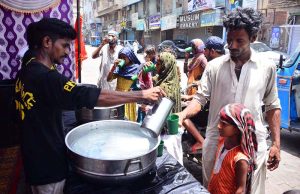 Volunteers serve cool water to people at Hyder chowk during a hot day in the city, providing relief to passersby to escape the heat wave amid rising temperatures