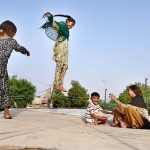 Young girls are enjoying jumping on a trampoline at Kotri Road