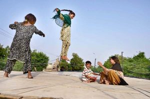 Young girls are enjoying jumping on a trampoline at Kotri Road