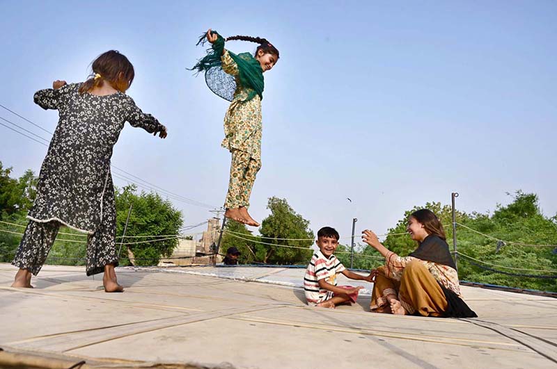 Young girls are enjoying jumping on a trampoline at Kotri Road