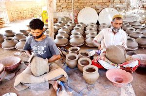 A craftsman is busy preparing clay-made stuff at his workplace in Kumhar para.